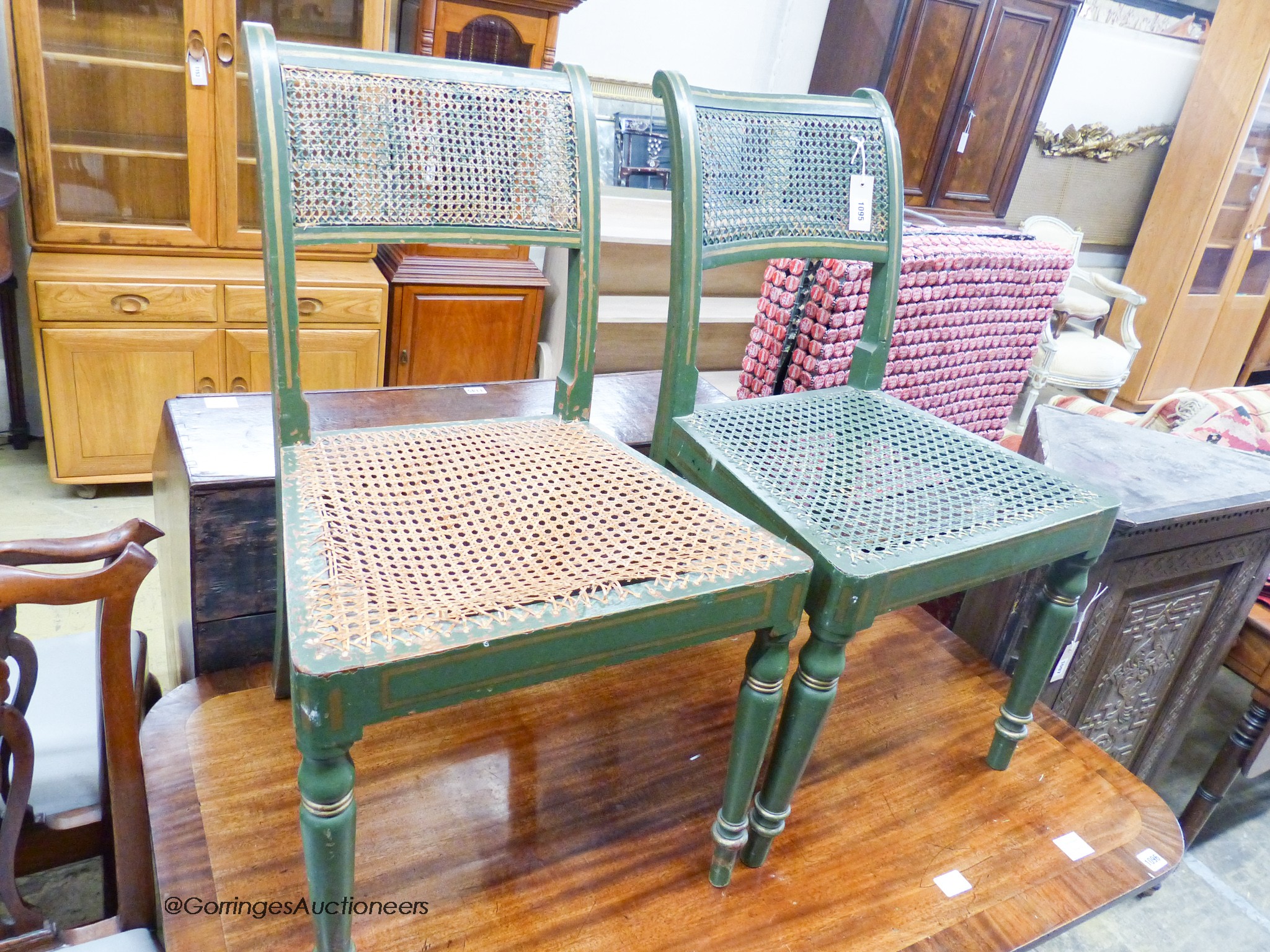 A pair of Regency style green and gilt cane seated chairs